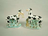 A pair of mid 19thC Staffordshire figures of black spotted greyhounds