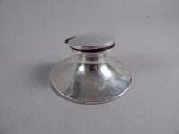 A silver capstan type inkwell