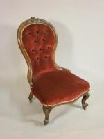 A Victorian walnut show frame spoon back nursing chair