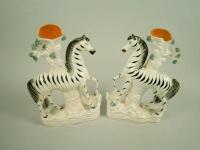 A pair of mid 19thC Staffordshire flat back spill vases