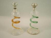 A pair of Victorian cut glass and silver mounted scent bottles