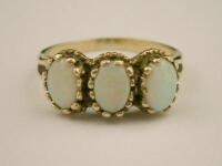 A 9ct gold three stone opal ring