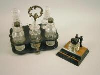 A Victorian ebonised papier mache six bottle cruet