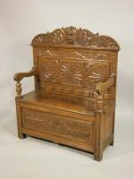 A late 19thC/early 20thC carved oak settle