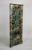 A reproduction ebonised and lacquer standing corner cupboard