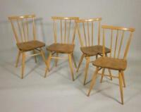 A set of four Ercol light coloured stick back retro style kitchen chairs