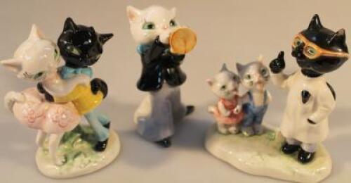 Three Goebel figures of cats.