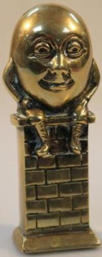 A Humpty Dumpty brass money box