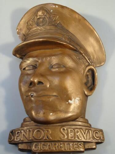 A Senior Service Cigarettes advertising mask head in gilt plaster