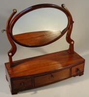 A George III mahogany oval toilet mirror