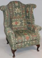 A Georgian style wingback armchair on cabriole legs