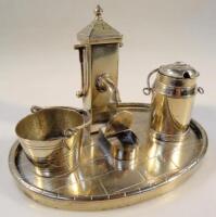 An EPNS novelty cruet set of four pieces in the form of a water pump and accessories