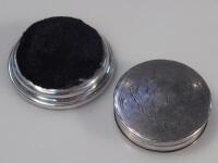 A silver pill box and pin cushion