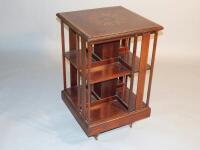 An Edwardian inlaid mahogany revolving bookcase. 82cm x 50cm x 50cm.