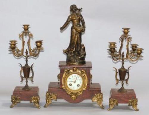 A late 19thC French mantel clock garniture of three pieces