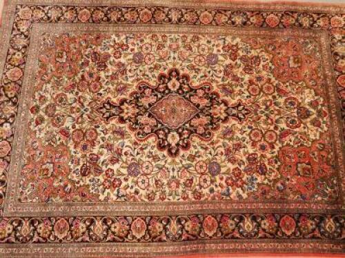 An Eastern bordered silk rug