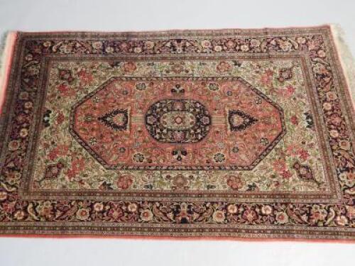 An Eastern bordered silk rug