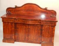 A Victorian flame mahogany serpentine fronted sideboard