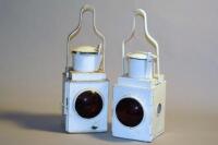 A pair of white painted railway coach lamps