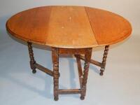 An oak oval dropleaf table