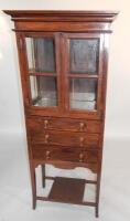 An early 20thC hardwood Colonial style glazed bookcase