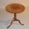 A Georgian oak tilt top tripod wine table.