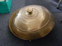 A circular Indian brass dish with a domed lid.