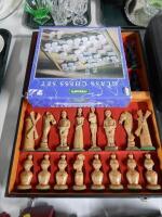 A glass chess set (boxed) and a cased chess set.