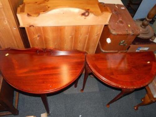 Two mahogany effect demi lune side tables.