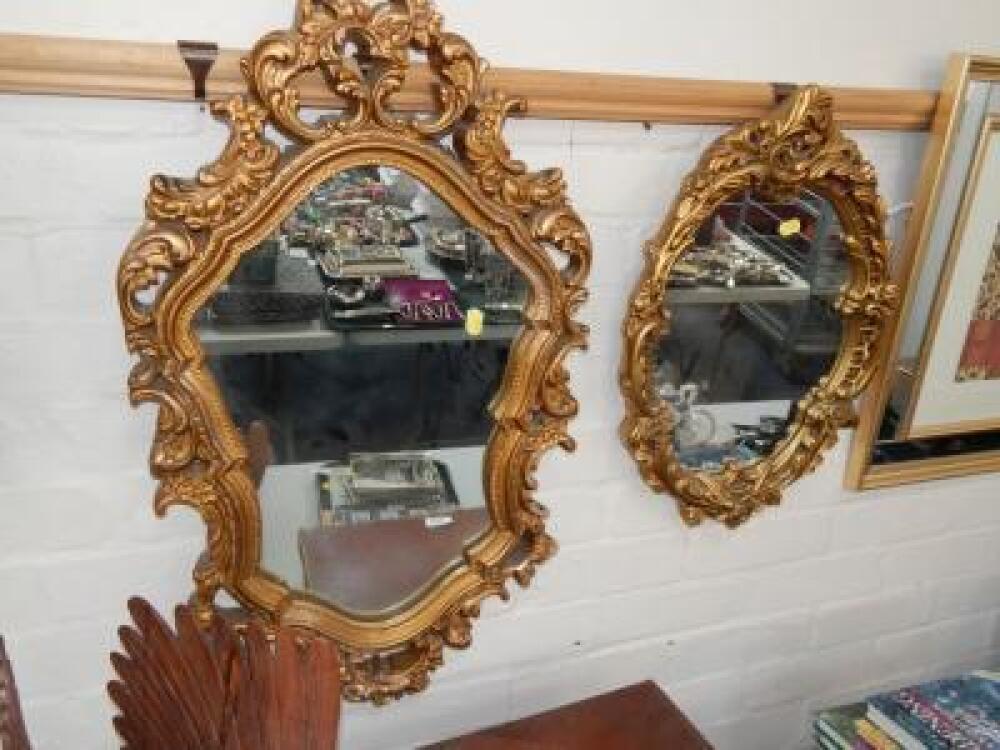 Two decorative plaster framed wall mirrors.