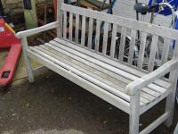 A slatted wooden garden bench.