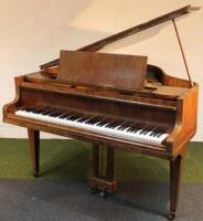 A Cramer over strung baby grand piano