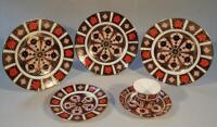 Four Royal Crown Derby Imari pattern plates and a cup and saucer