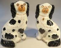 A pair of Staffordshire black and white seated spaniels