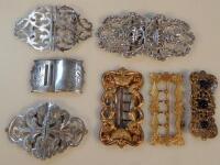 Two pierced silver belt buckles and five others