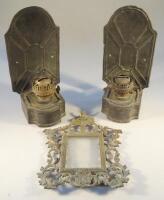 A pair of wall mounted stamped metal oil lamps