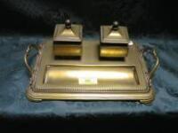 A brass desk stand, the rectangular base fitted with two square inkweels