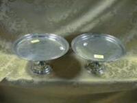 A pair of EPNS tazza, of plain design, with raised borders, on knopped