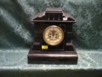 A 19thC slate mantel clock of eight day chiming movement