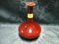 A flambe bottle vase, with compressed body and crested rim, 8 1/4" high