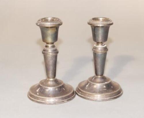 A pair of modern dwarf silver candlesticks