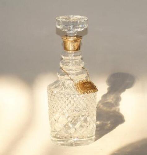 A silver collared pressed glass mallet shaped decanter