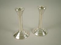 A pair of silver Art Deco style candlesticks of tapering form