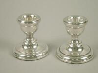 A pair of silver dwarf candlesticks