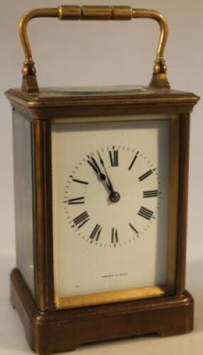 An early 20thC brass carriage clock the circular numeric dial signed Fabrique D Paris