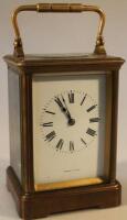 An early 20thC brass carriage clock the circular numeric dial signed Fabrique D Paris