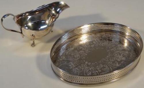 A silver plated tray of oval form with a galleried edge and bright cut decoration to the body 21 cm