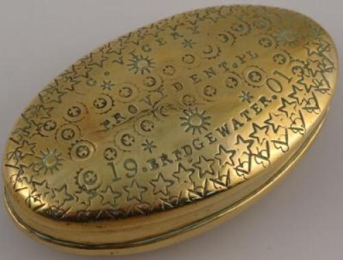 A brass snuff box of oval form