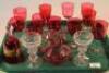 A quantity of various cranberry and clear glass drinking glasses