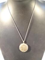 A silver gilt locket of part etched circular form